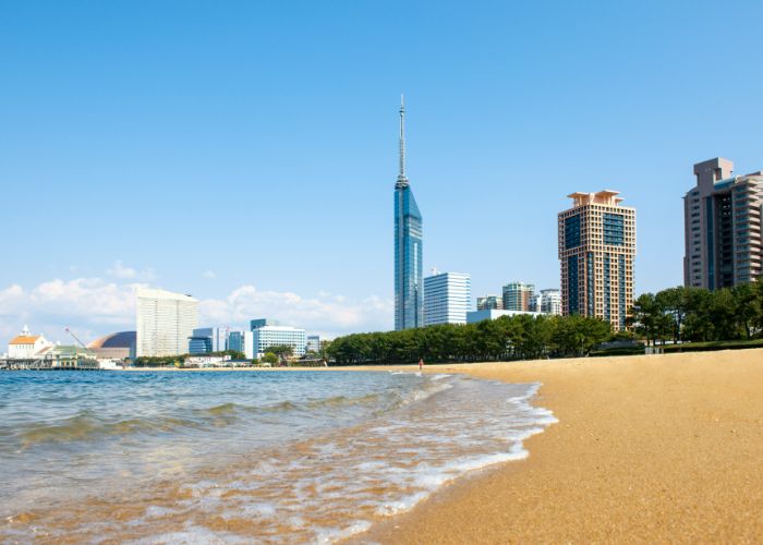 Looking up at Fukuoka Tower from the sands of Momochi Seaside Park.